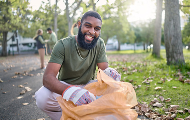 Image showing Black man, volunteer portrait and plastic bag for community park cleanup, recycling or cleaning. Ngo person outdoor in nature to recycle, earth day or happy about a clean from pollution enviroment