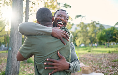 Image showing Charity, happy and hug with volunteer friends in a park for community, charity or donation of time together. Support, teamwork or sustainability with a black man and friend hugging outdoor in nature