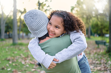 Image showing Nature, love and child hugging mother in park with smile on autumn morning for family outdoor time together. Hug, play and laugh, mom and small girl in garden having fun at picnic or forest walk.