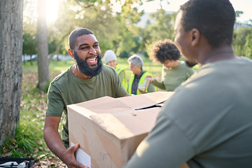 Image showing Community service, black man and giving box in park of donation, volunteering or social responsibility. Happy guy, NGO workers and helping with package outdoor of charity, support or society outreach