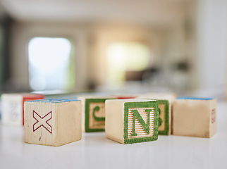 Image showing Wood blocks, table and letters for learning, education or childhood development at home. Colorful wooden cube toys to learn numbers or alphabet for back to school, spelling or mathematics to read