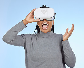 Image showing Happy, gaming and vr with black woman and headset in metaverse for future, cyber or 3d system. Media, ui and technology with gamer for internet, augmented reality or digital in blue background studio