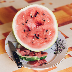 Image showing Fresh juicy watermelon against natural green background
