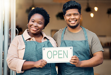 Image showing Portrait, couple and open sign by small business owners happy at coffee shop, cafe and support together. Team, restaurant and black people smiling due to startup growth and proud of success or vision