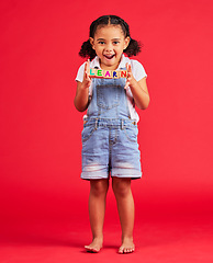 Image showing Learn blocks, education and portrait of child on red background for learning, reading and kindergarten. Child development, knowledge and excited, happy and young girl smile with letters on wood toys