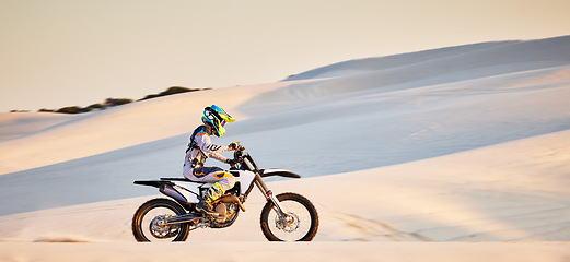 Image showing Moto cross, sand mountain or man on bike in Dubai for sport workout, sunset ride or exercise on hill. Nature, sky or person riding for speed adventure freedom in desert for training, fitness or race