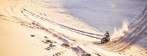 Image showing Sand, mockup and motorcycle with a sports man riding offroad on dunes outdoor in nature for recreation. Desert, bike and mock up with a male athlete taking a ride for fun, freedom or adventure