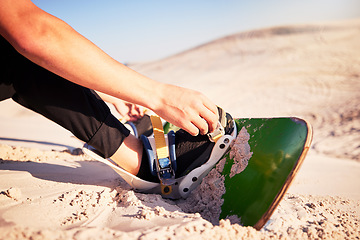 Image showing Sand board, adventure and man with shoes for desert surfing, extreme sports and action hobby in nature. Freedom, holiday travel and feet of dune surfer outdoors for fitness, exercise and training