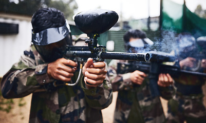 Image showing Paintball game, gun smoke and men in war, competition or sports challenge outdoor for target shooting. Military, soldier or army group doing teamwork training mission in woods with people or friends