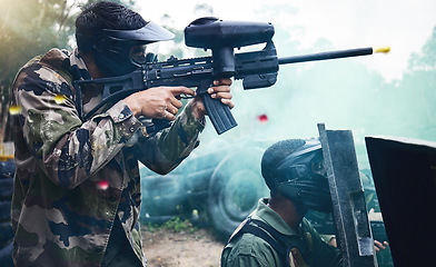 Image showing Training, paintball and men with shield and gun in camouflage safety gear at military game target practice. Teamwork, shooting sports and war games, play with rifle and working together at army park.