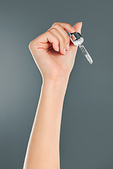 Image showing Skincare, hand and serum pipette in a studio for health, wellness and natural skin routine. Cosmetic, beauty and hyaluronic acid facial oil dropper for facial treatment isolated by a gray background.