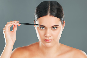 Image showing Eyebrow brush, beauty and portrait of woman in studio for headshot, skincare transformation and cosmetics. Face, makeup and brushing brows with facial tool, model and hair on eyes for clean aesthetic