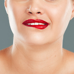 Image showing Woman bite lips with lipstick, face zoom and makeup, flirt with red cosmetics isolated on studio background. Sexy mouth, beauty and skincare with cosmetic wellness and glow, facial and healthy skin