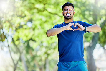 Image showing Runner man, smile and heart hands in portrait for wellness, strong body or fitness by trees in park. Outdoor training, nature workout or running exercise or young guy for happiness, love or self care