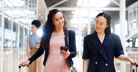 Image showing Business woman, phone and walking with luggage in travel for work trip partnership at the workplace. Happy women talking or chatting on a walk to the airport for opportunity or journey with suitcase