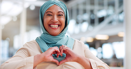 Image showing Face, hands and heart with a muslim businesswoman walking in her office while happy at work. Portrait, laughing or smile with an islamic and carefree woman employee taking a walk while working