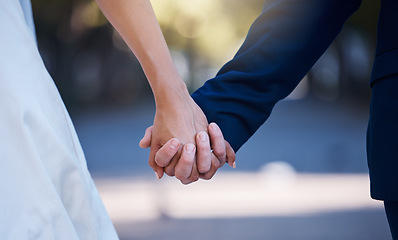 Image showing Love commitment, wedding and couple holding hands outdoors for support. Partnership, diversity and affection, care or romance of interracial man, woman or bride and groom at ceremony for marriage day