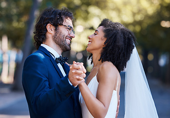 Image showing Wedding, couple and dancing outdoor for marriage celebration event together with love. Happy interracial man and woman at nature park with care, partnership and commitment with a smile and happiness