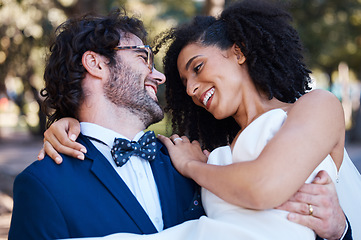 Image showing Happy couple, wedding and carrying bride outdoor at marriage celebration event with love. Interracial man carries woman in arms at park for care, partnership and support with a smile while walking