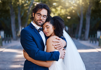 Image showing Wedding, hug and love of a couple outdoor for marriage celebration event, commitment and care. Interracial man and woman at park with trust, partnership and embrace for gratitude for life partner