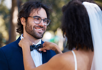 Image showing Wedding, happy couple and bow tie outdoor at marriage celebration event together with care. Smile of groom and bride at a park with love, partnership and support or commitment while helping with suit