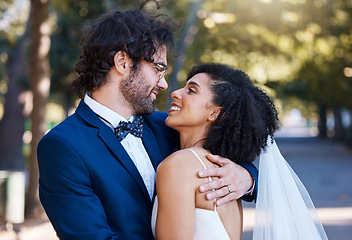 Image showing Marriage, happy couple and wedding celebration event outdoor for love, care and commitment. Interracial man and woman married at a park with trust, partnership and a hug while together for support