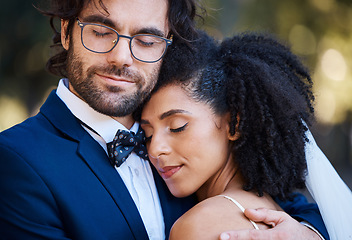 Image showing Interracial couple, wedding and hug for love at marriage celebration event with commitment. Happy married man and woman together with trust, partnership and support or care with safety and security