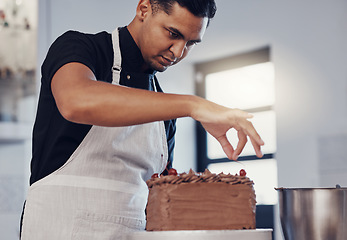 Image showing Kitchen, baking and man decorating cake with chocolate sprinkles and frosting with focus and skill. Sweets, small business and baker decorating dessert for birthday event and pastry chef in bakery.