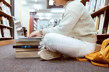 Image showing Books, laptop or student typing on library floor for research, knowledge or development for future growth. Online project, university or school girl studying or learning college information on campus