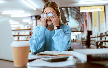 Image showing Woman student with glasses, stress with headache and burnout, tired about paper deadline or study for exam in library. Campus, college studying fatigue with scholarship problem, pain and eye strain