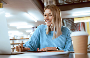 Image showing Education, university and happy woman in library with laptop, research and books for school project or exam. Smile, internet and college phd student studying with technology and elearning on campus.