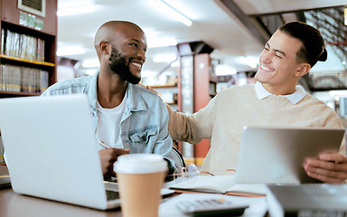 Image showing Students, men and library with study support at desk with laptop, tablet and happy for learning opportunity. Student friends, laugh together and vision for university success, diversity and teamwork