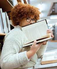 Image showing Books, education or black woman in a library reading for knowledge or development for future growth. Scholarship, portrait or focused school girl studying or learning college information on page