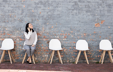 Image showing Phone call, thinking in waiting room and woman with chairs, job recruitment and employment with smile in Japan. Happy person sitting on chair with smartphone, smiling and talking with mockup space.