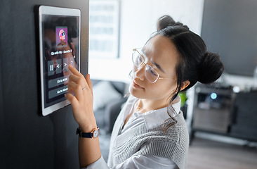 Image showing Music, tablet and Asian woman with digital system in home, apartment and living room. Technology, futuristic design and girl typing song, track and audio on ai software, biometrics and user interface