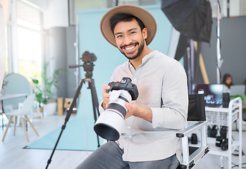 Image showing Portrait, photographer and man with camera in studio, happy and smile before a photo shoot. Face, photography and asian guy relax during professional, shooting for model, design and creative career