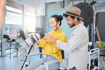 Image showing Photography, creative and man talking to a model to choose a image on the camera from the photoshoot. Creativity, art and male photographer speaking to a woman for the best picture in artistic studio