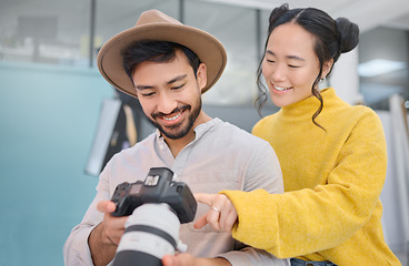 Image showing Creativity, photographer and woman in discussion with a camera choosing a image from photoshoot. Photography, art and young cameraman talking to a model to choose the best picture in creative studio.