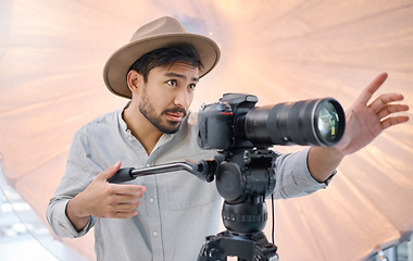 Image showing Photographer, camera and photoshoot with man and photography, focus and lens with direction and creativity. Creative, art and fashion with person on set or photo studio with cameraman working