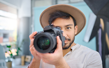 Image showing Camera, portrait and photographer man in studio for photo shoot, creative and confident, professional and setup. Magazine, photography and face of asian male taking pictures, photo and backstage