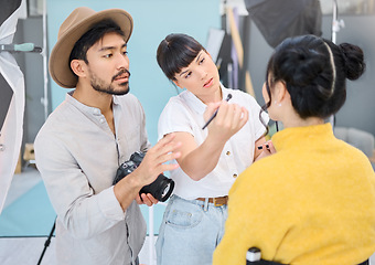 Image showing Makeup, artist and woman with photographer and model in studio for artistic, process and photo shoot. Man, photographer and girl coworking on makeover, glamour and beauty during backstage session