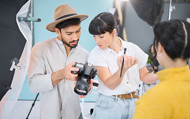 Image showing Makeup artist, photographer and model checking pictures during artistic, process and glamour shooting in studio. Man, photography and lady coworking on creative, project and magazine cover together