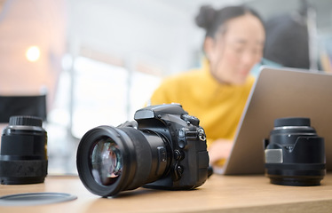 Image showing Photography camera, laptop and photographer editing photoshoot, focus on digital art or retouching artistic photo. Studio, creative vision and professional Asian woman working on creativity process