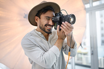 Image showing Photography, studio and camera with a man photographer taking a picture backstage during a photoshoot. Creative, light and production with a male using a photographic lens to take a photograph