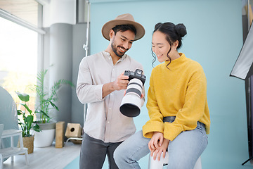 Image showing Creative, photographer and model choosing a picture on the camera from the photoshoot in the studio. Photography, creativity and cameraman talking to a woman for the best image on a artistic set.