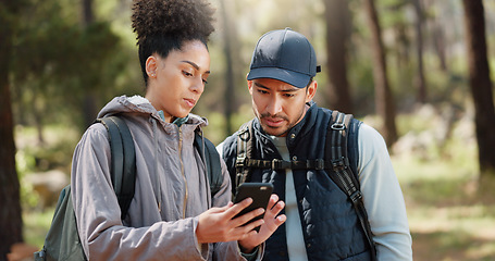 Image showing Hiking, smartphone and travel couple with location search, online travel guide or nature journey planning together in a forest on 5g network. Backpack trekking people using phone mobile app in woods