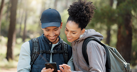 Image showing Hiking, smartphone and travel couple with location search, online travel guide or nature journey planning together in a forest on 5g network. Backpack trekking people using phone mobile app in woods