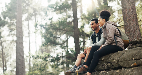 Image showing Hiking, forest and nature couple people on rock for journey, adventure or wellness lifestyle with trees, fitness gear and backpack. Trekking, relax and diversity friends travel in mountains or woods