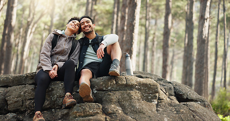 Image showing Hiking, forest and nature couple people on rock for journey, adventure or wellness lifestyle with trees, fitness gear and backpack. Trekking, relax and diversity friends travel in mountains or woods