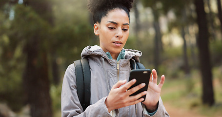 Image showing Phone, hiking woman in nature for a gps location, travel and freedom in mountains of Peru during a holiday. Young, thinking and black female with a mobile for communication while trekking in a forest